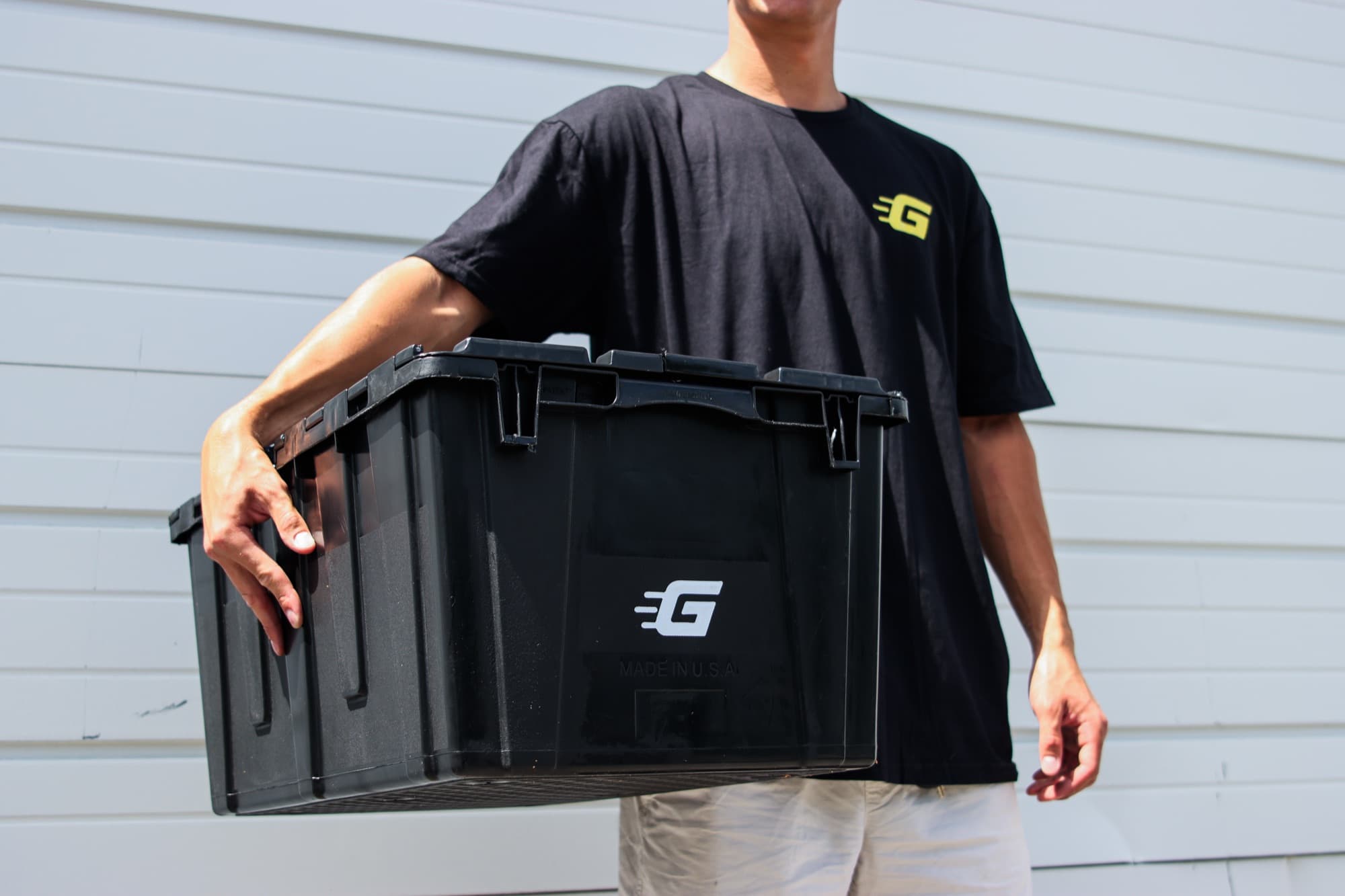Carrying a black Ghatt2Go bin by its molded grip